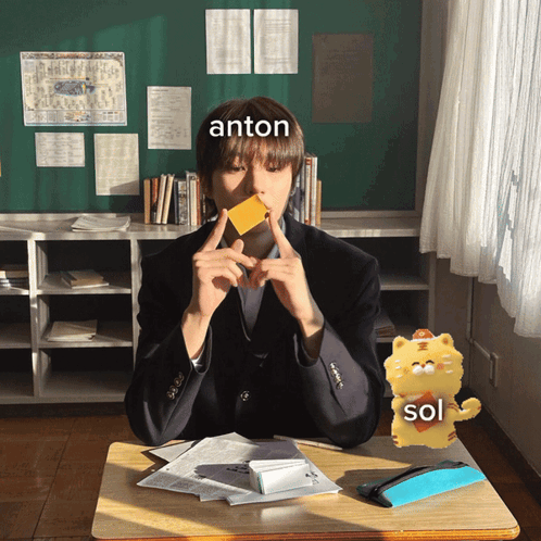 Boy Sitting At Desk With Anton Written On Forehead GIF
