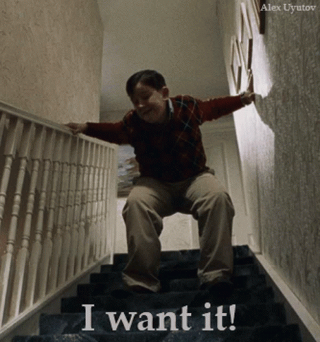 A Boy Sitting On A Set Of Stairs With The Words " I Want It " Written On The Bottom GIF