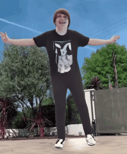 A Boy Wearing A Black Shirt With A Bunny On It GIF