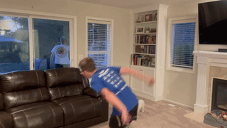A Boy Wearing A Blue Shirt That Says ' I Love You ' On The Back GIF