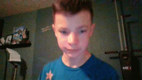 A Boy Wearing A Blue Shirt With A White Star On It GIF