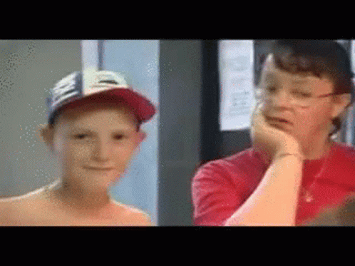 A Boy Wearing A Hat And A Woman Wearing Glasses GIF