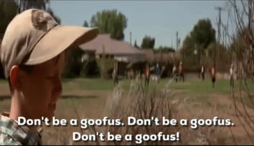 A Boy Wearing A Hat Is Standing In A Field With A Group Of People . GIF