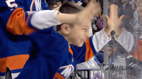 A Boy Wearing A Jersey With The Letter M On It Is Giving A High Five GIF