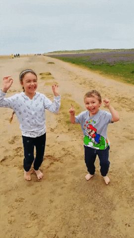 A Boy Wearing A Mario Shirt Is Standing Next To A Girl On A Dirt Road GIF
