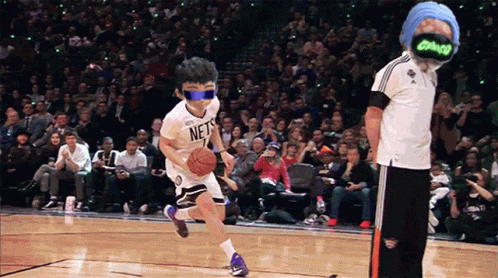 A Boy Wearing A Nets Jersey Dribbles A Basketball On A Court GIF
