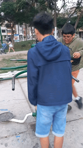 A Boy Wearing A Puma Sweatshirt Stands Next To A Boy Wearing A Blue Jacket GIF