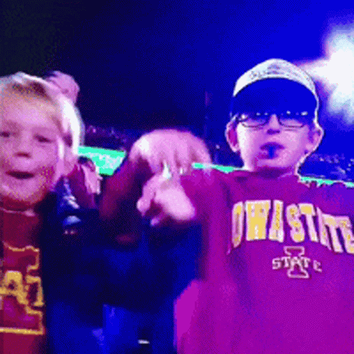 A Boy Wearing A Purple Iowa State Shirt GIF