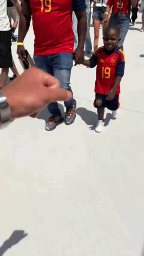 A Boy Wearing A Red Jersey With The Number 19 On It GIF