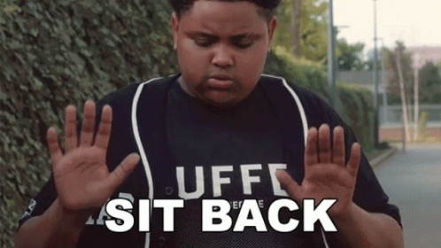 A Boy Wearing A Shirt That Says " Uff Sit Back " GIF