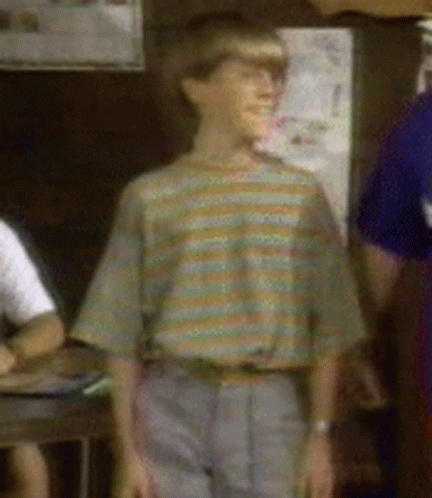 A Boy Wearing A Striped Shirt And Gray Pants GIF