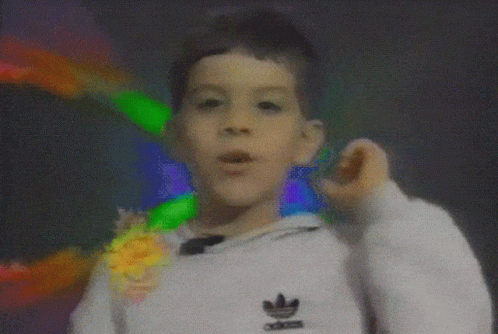 A Boy Wearing A White Adidas Sweatshirt Is Making A Funny Face GIF