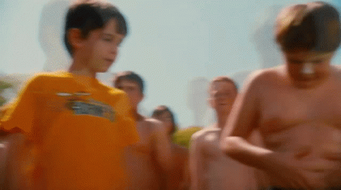 A Boy Wearing A Yellow Shirt With The Word Eagles On It GIF