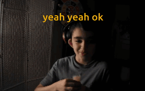 A Boy Wearing Headphones Says " Yeah Yeah Ok " GIF