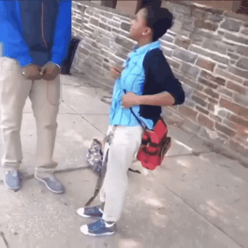 A Boy With A Backpack Is Talking To A Man GIF