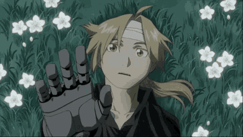 A Boy With A Bandage On His Head Is Laying In The Grass GIF