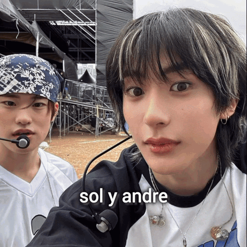 Boy With Bandana Standing Next To Boy With Sol Y Andre Shirt GIF