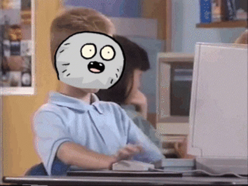 A Boy With A Cartoon Face On His Face Is Sitting At A Desk In Front Of A Computer GIF