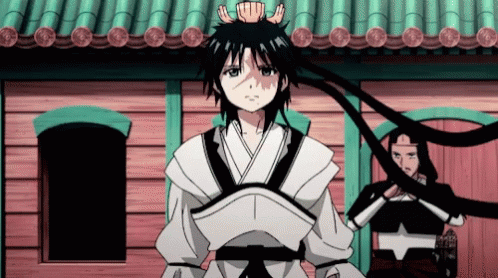A Boy With A Crown On His Head Is Standing In Front Of A Building GIF