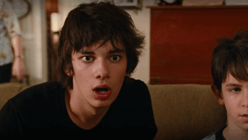 A Boy With A Surprised Look On His Face Looks At The Camera GIF
