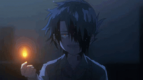 A Boy With A Tattoo On His Forehead Holds A Lit Match GIF
