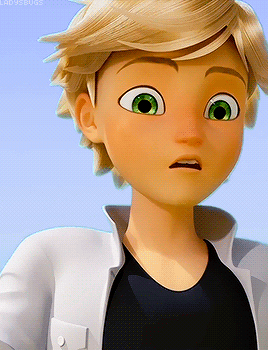 A Boy With Blonde Hair And Green Eyes Is Wearing A Black Shirt And A White Jacket GIF