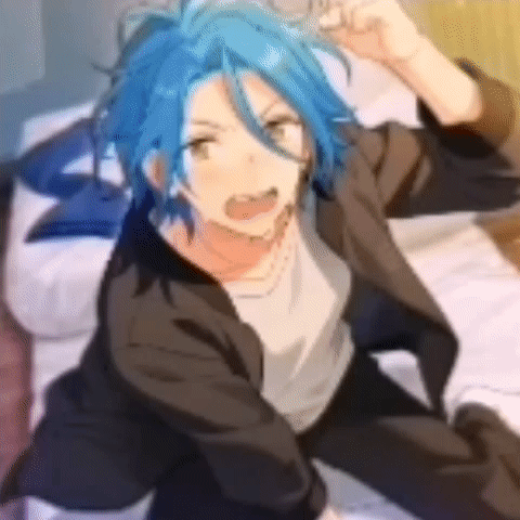 A Boy With Blue Hair Is Sitting On A Bed With His Hands In The Air . GIF