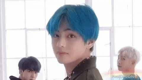 A Boy With Blue Hair Is Standing In Front Of A Window . GIF