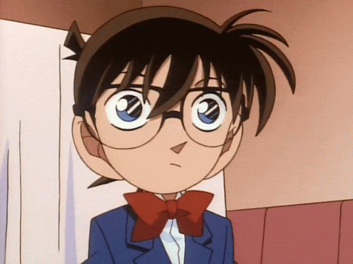 A Boy With Glasses And A Red Bow Tie Looks At The Camera GIF