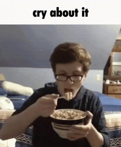 a boy with glasses is eating a bowl of cereal with the words cry about it above him