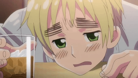 A Boy With Green Eyes Is Leaning On A Table With A Glass Of Beer In Front Of Him GIF