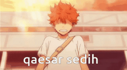 A Boy With Orange Hair Is Standing In Front Of A Building With The Words Qaesar Sedih Written On It GIF