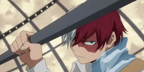 A Boy With Red Hair And Blue Eyes Is Holding A Bat Over His Head GIF