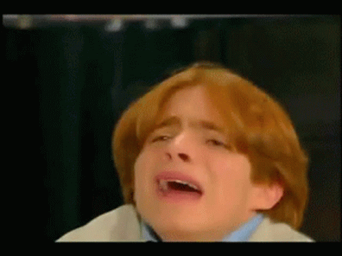 A Boy With Red Hair Is Crying With His Mouth Open GIF