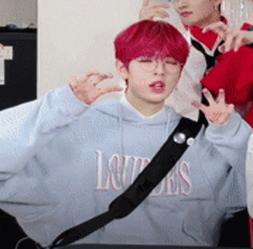 A Boy With Red Hair Is Wearing A Blue Hoodie That Says Louis On It . GIF