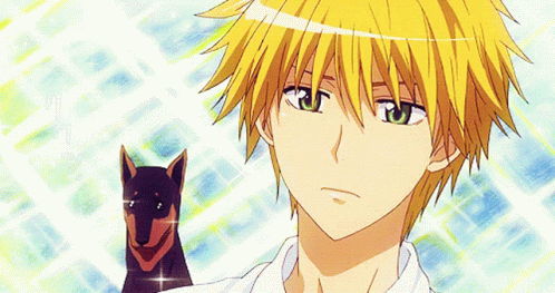A Boy With Yellow Hair And Green Eyes Is Holding A Dog GIF