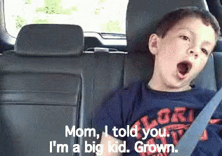 A Boy Yawning In The Back Seat Of A Car GIF