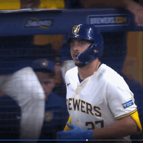 a brewers baseball player wearing a helmet and number 27