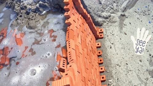 A Brick Wall Is Being Built With A Hand That Says See Ya GIF