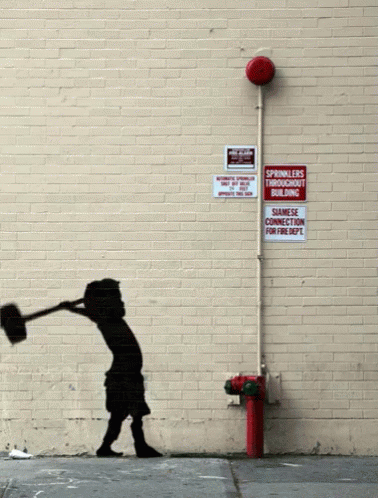 A Brick Wall With A Red Fire Hydrant And A Sign That Says Sprinklers Throughout Building GIF