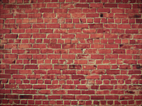 A Brick Wall With Flames Coming Out Of The Center GIF