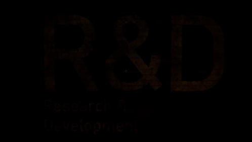 A Brick Wall With The Words Research & Development Written On It GIF