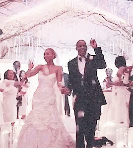 A Bride And Groom Are Dancing In Front Of A Crowd At Their Wedding GIF