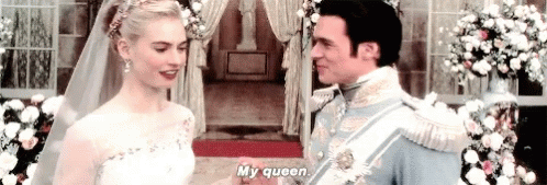 A Bride And Groom Are Holding Hands At Their Wedding And The Bride Is Talking To The Groom . GIF