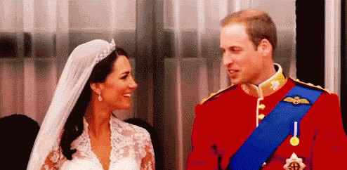 A Bride And Groom Are Looking At Each Other . GIF
