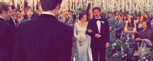 A Bride And Groom Are Walking Down The Aisle At Their Wedding Ceremony GIF