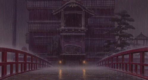 A Bridge Over A Body Of Water With A Building In The Background In The Rain GIF