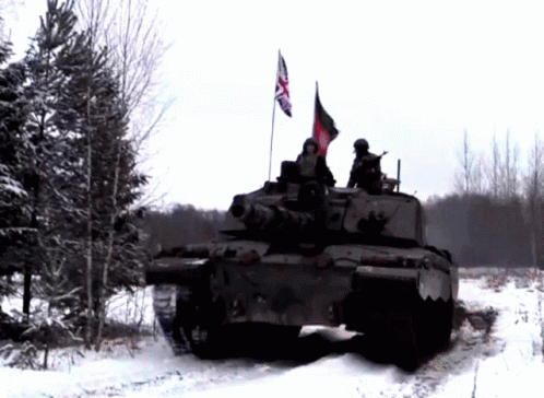 A British Flag Is Flying From The Top Of A Military Vehicle GIF