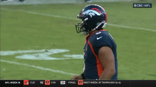 A Broncos Football Player Celebrates On The Field During A Game GIF