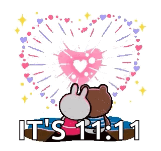 A Brown Bear And A Bunny Are Sitting On A Beach Watching Fireworks . GIF